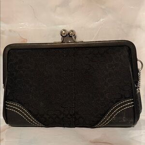 Coach Soho Kiss Lock Wristlet in black signature jacquard with leather trim.